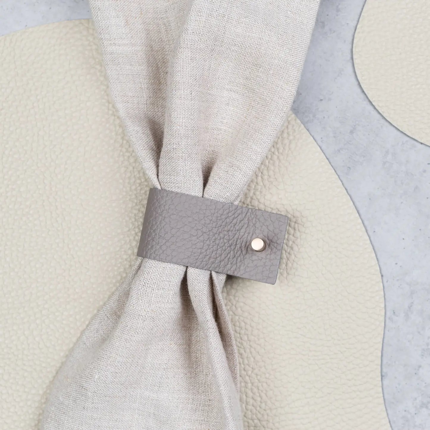 Authentic leather beige napkin ring with metal accent